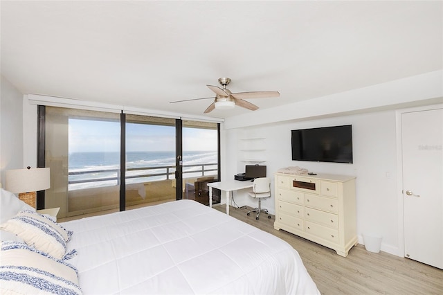 bedroom featuring ceiling fan, a wall of windows, light wood-type flooring, and access to outside