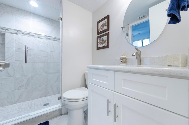 bathroom featuring toilet, walk in shower, and vanity