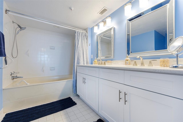 bathroom with vanity, tile patterned flooring, a textured ceiling, and shower / tub combo with curtain