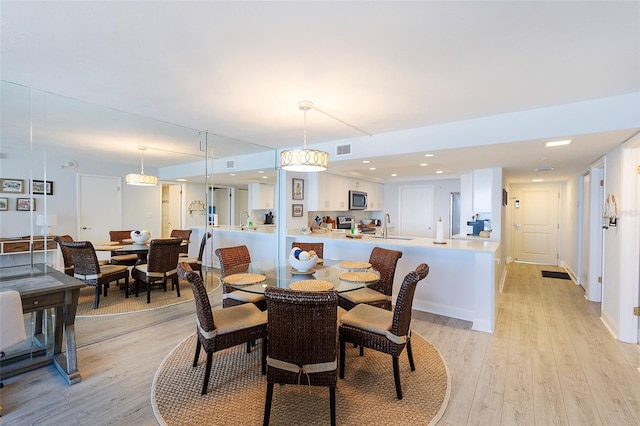 dining area featuring light hardwood / wood-style floors and sink