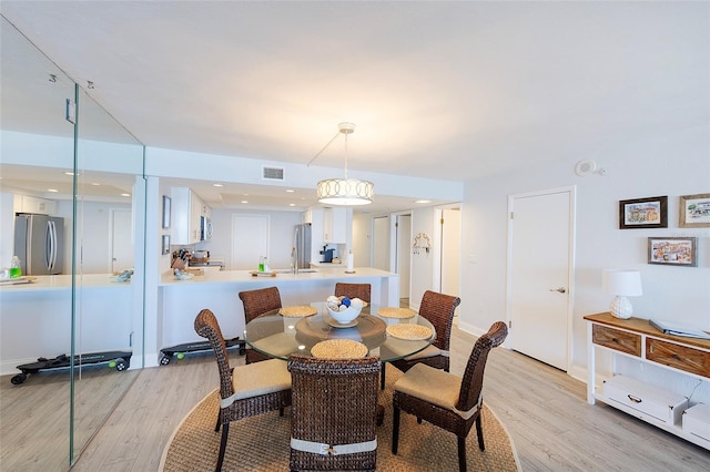 dining room with light wood-type flooring