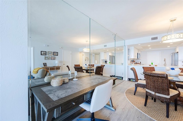 dining room featuring hardwood / wood-style flooring and sink