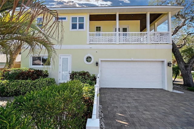 view of front of house featuring a balcony and a garage