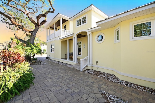 rear view of house with a balcony and a patio area