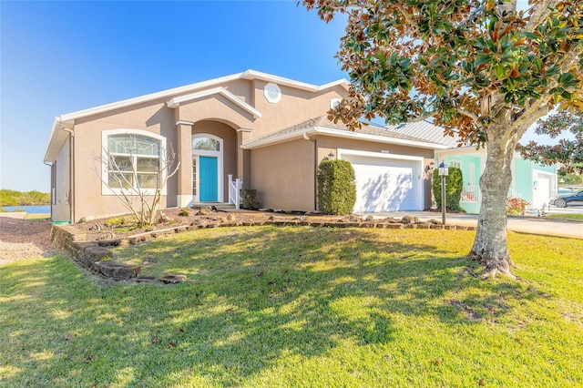 view of front of property featuring a front yard and a garage