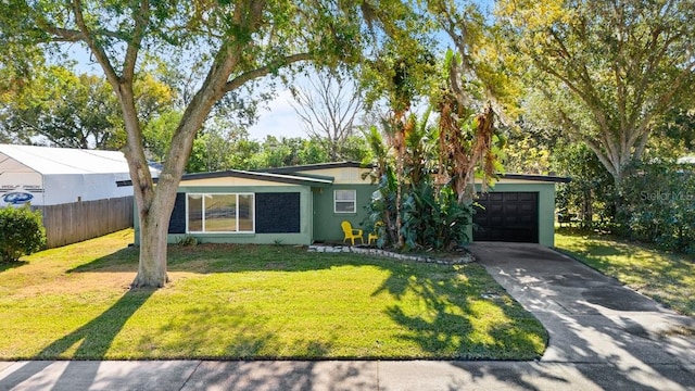 single story home featuring a garage and a front lawn