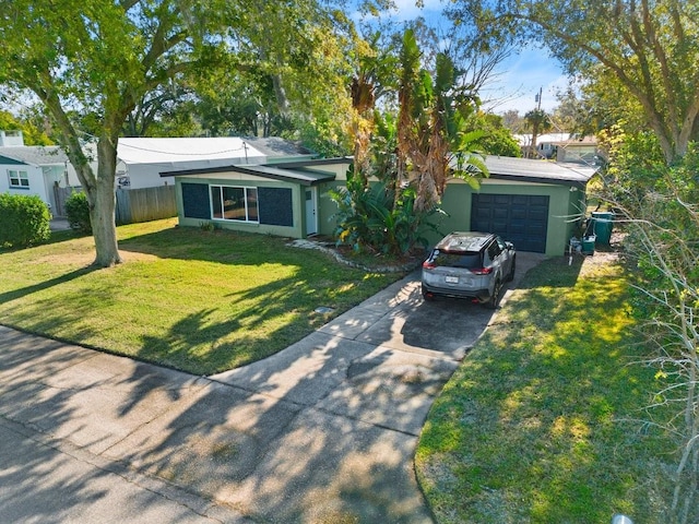 single story home featuring a garage and a front yard