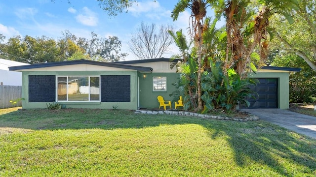 single story home with a garage and a front lawn