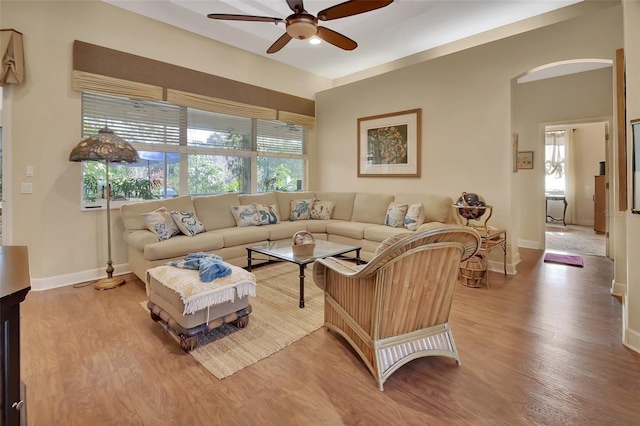 living room featuring wood-type flooring and ceiling fan