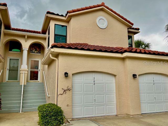 mediterranean / spanish-style home with a garage