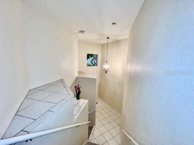 stairs featuring tile patterned flooring