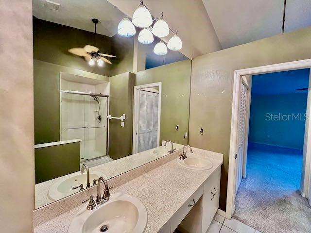 bathroom with an enclosed shower, tile patterned floors, vanity, vaulted ceiling, and ceiling fan