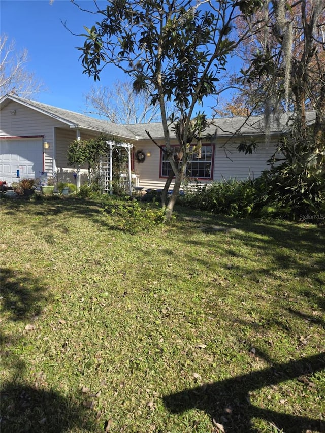 view of front facade with a front lawn and a garage