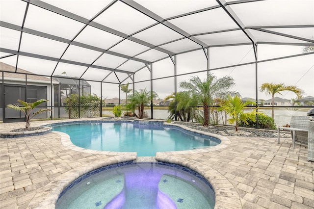 view of swimming pool featuring an in ground hot tub, a lanai, and a patio area