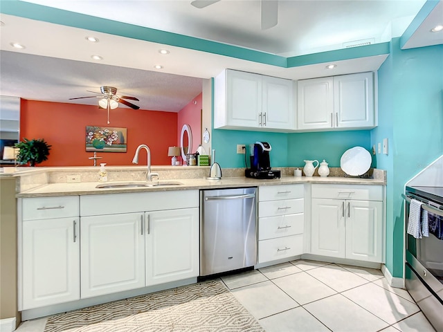 kitchen featuring light tile patterned floors, sink, white cabinets, and stainless steel appliances