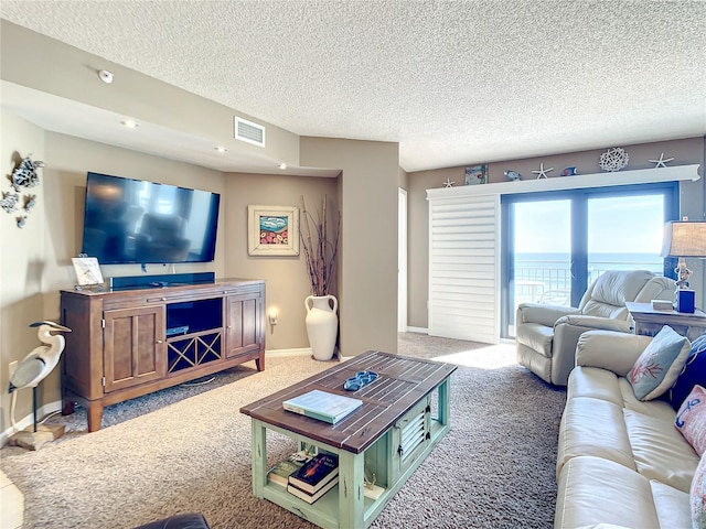 living room featuring carpet floors and a textured ceiling