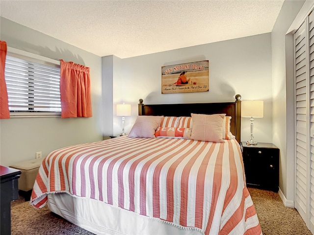 bedroom featuring carpet and a textured ceiling