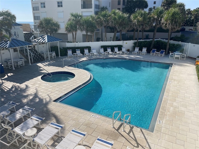 view of pool featuring a patio and a community hot tub