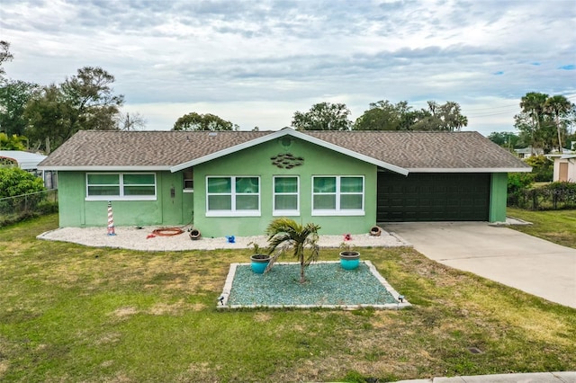 rear view of property featuring a garage and a yard