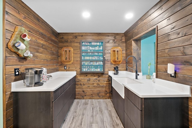 bathroom with vanity, wooden walls, and wood-type flooring