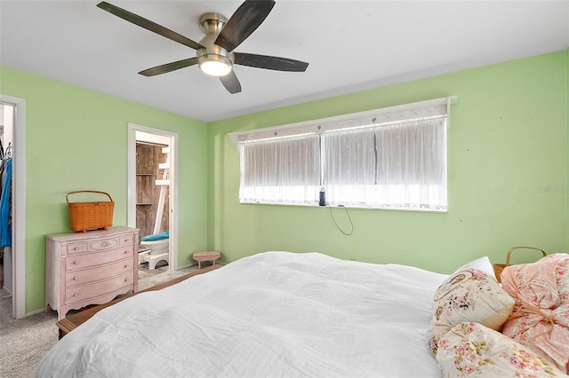 carpeted bedroom with ceiling fan and ensuite bath