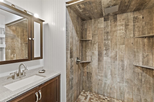 bathroom featuring walk in shower and vanity