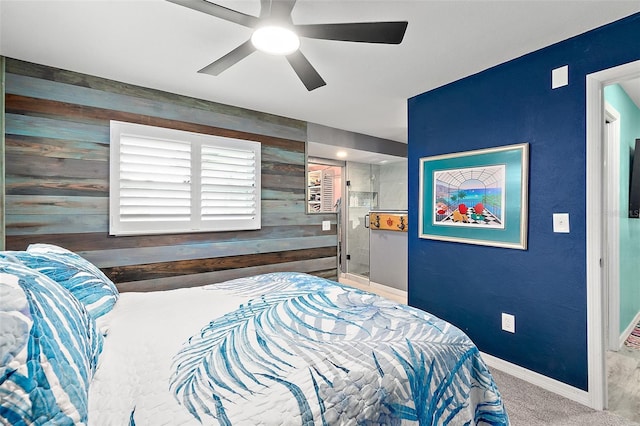 bedroom featuring ceiling fan, carpet, and wood walls