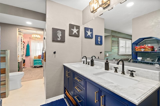 bathroom featuring toilet, vanity, and tile patterned flooring