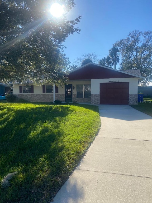 ranch-style home with a front lawn and a garage