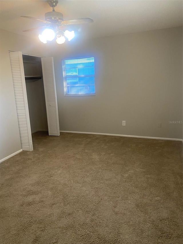 unfurnished bedroom with ceiling fan, a closet, and carpet floors