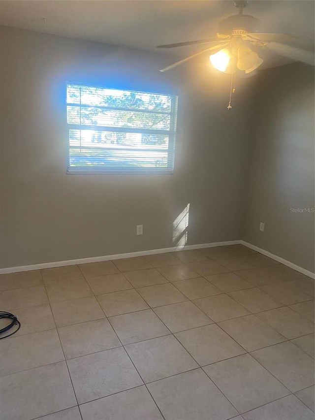 tiled empty room with ceiling fan