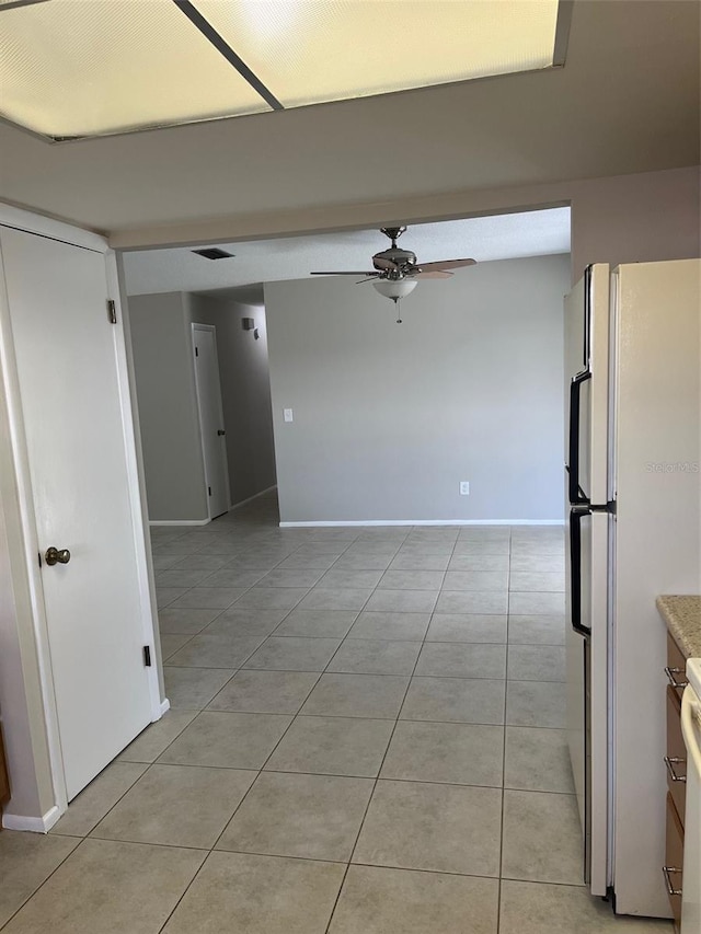 2408 Victory Palm Dr, Edgewater, FL 32141 - kitchen featuring freestanding refrigerator, a ceiling fan, light tile patterned floors, and baseboards