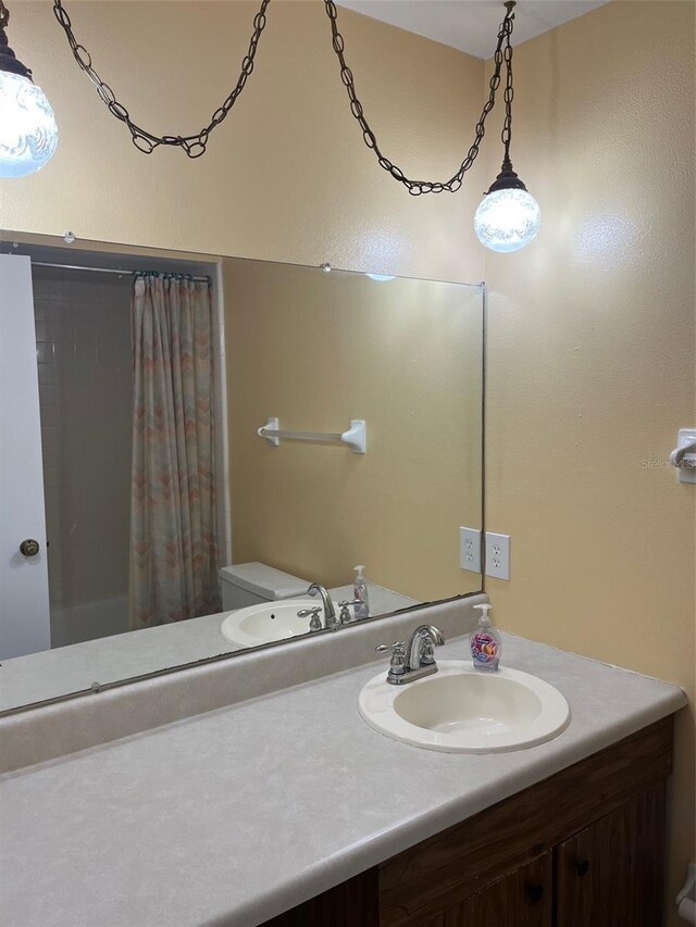 2408 Victory Palm Dr, Edgewater, FL 32141 - bathroom featuring vanity, a shower with curtain, and toilet
