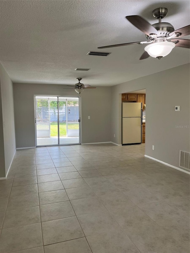 2408 Victory Palm Dr, Edgewater, FL 32141 - unfurnished room featuring a ceiling fan, light tile patterned flooring, a textured ceiling, and baseboards