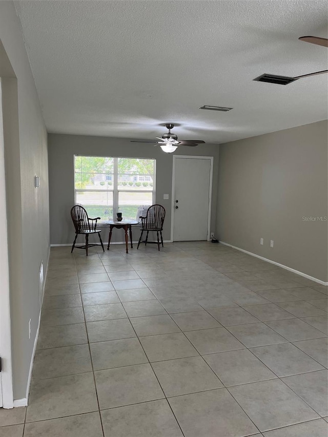 2408 Victory Palm Dr, Edgewater, FL 32141 - unfurnished room featuring ceiling fan, a textured ceiling, light tile patterned flooring, and baseboards