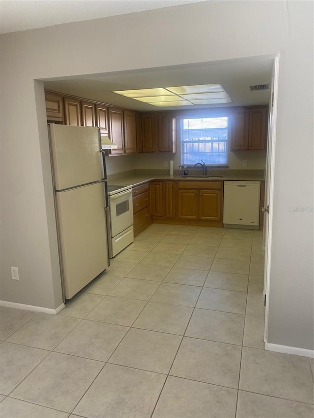 2408 Victory Palm Dr, Edgewater, FL 32141 - kitchen featuring white appliances, a sink, exhaust hood, light tile patterned floors, and baseboards