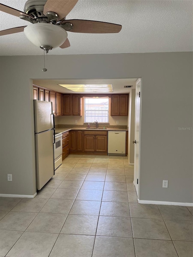 2408 Victory Palm Dr, Edgewater, FL 32141 - kitchen featuring white appliances, a sink, a ceiling fan, light tile patterned floors, and a textured ceiling
