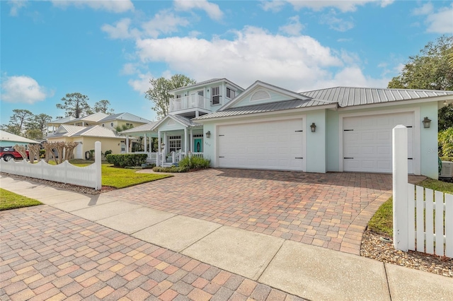 view of front of house with a garage and a balcony