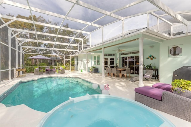 view of pool with a lanai, an outdoor hangout area, ceiling fan, and a patio area