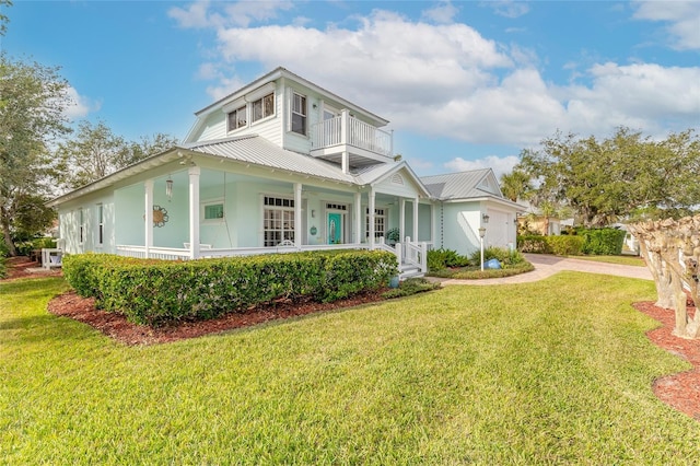 view of front of home featuring a balcony and a front yard