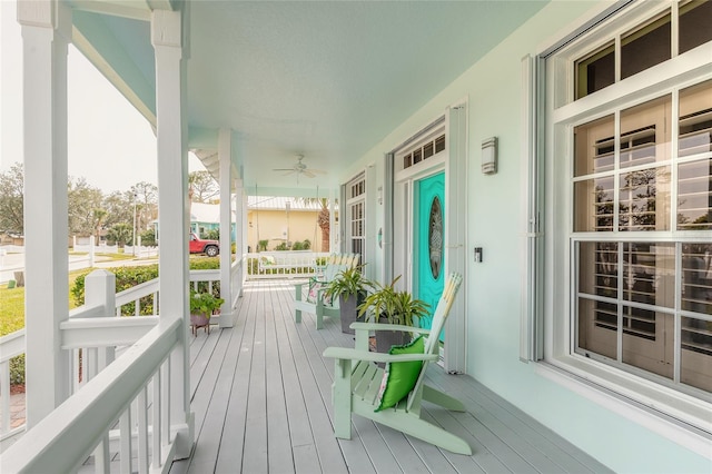 wooden deck with ceiling fan and covered porch