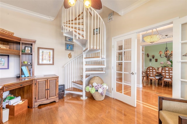 interior space featuring ornamental molding, french doors, and light wood-type flooring