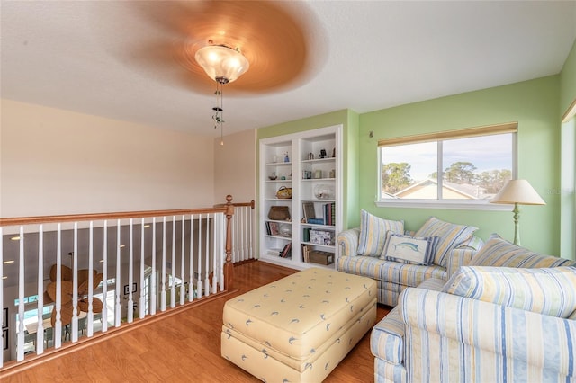 living room featuring hardwood / wood-style flooring and built in shelves