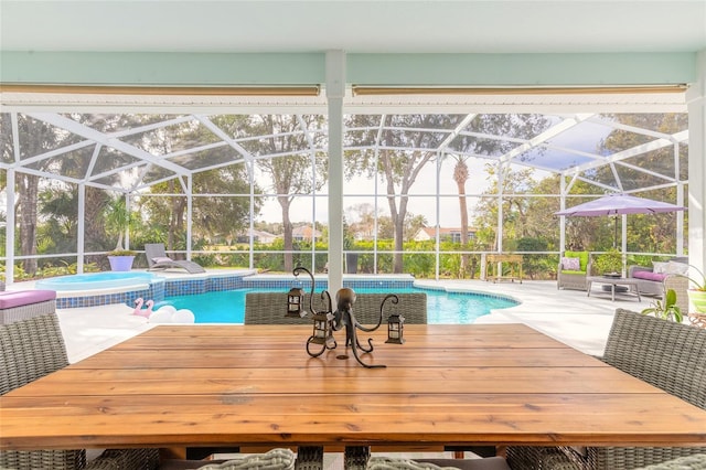 view of swimming pool featuring glass enclosure, an in ground hot tub, and a patio