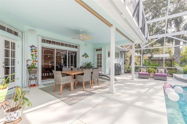 sunroom / solarium featuring ceiling fan