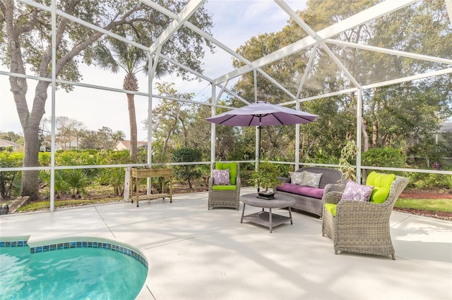 view of pool with glass enclosure, a patio area, and an outdoor hangout area