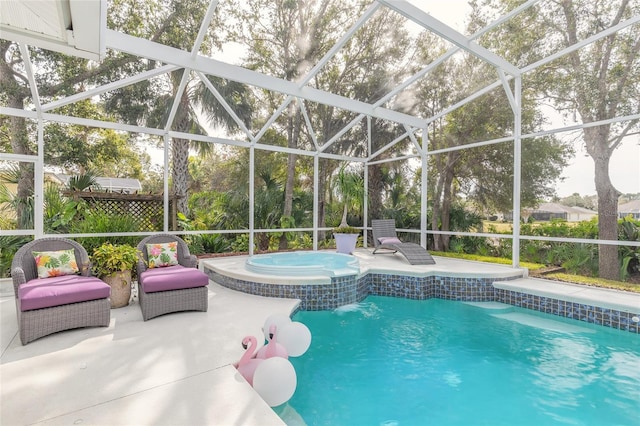 view of pool featuring glass enclosure, an in ground hot tub, and a patio