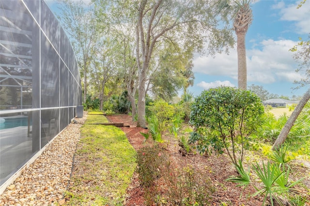 view of yard featuring a lanai