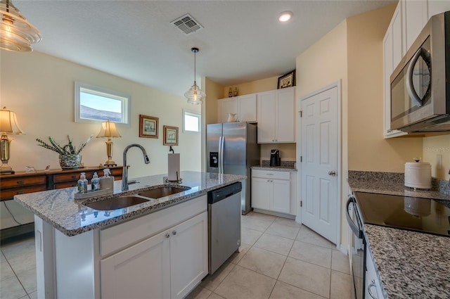 kitchen with pendant lighting, sink, white cabinetry, a kitchen island with sink, and appliances with stainless steel finishes