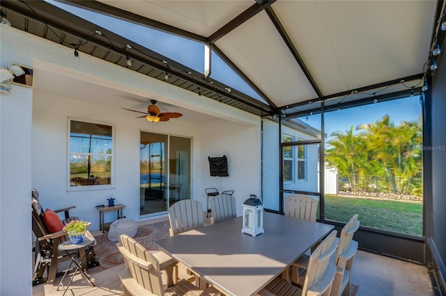 sunroom / solarium featuring ceiling fan and vaulted ceiling